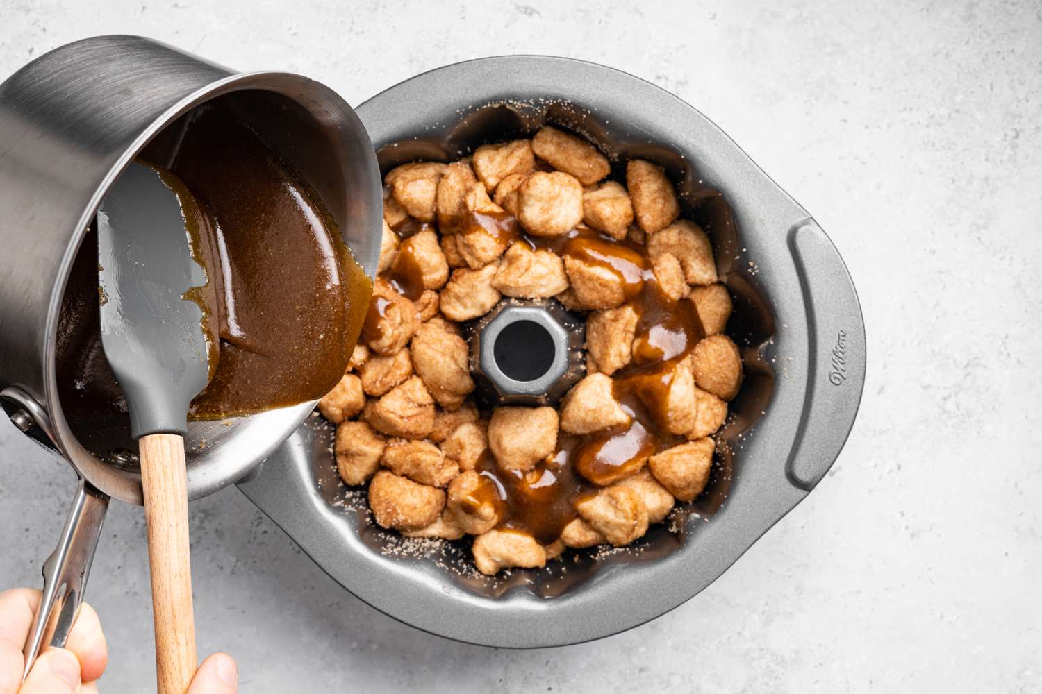 Brown Sugar Sauce Poured into Bundt Pan, Topping the Monkey Bread 