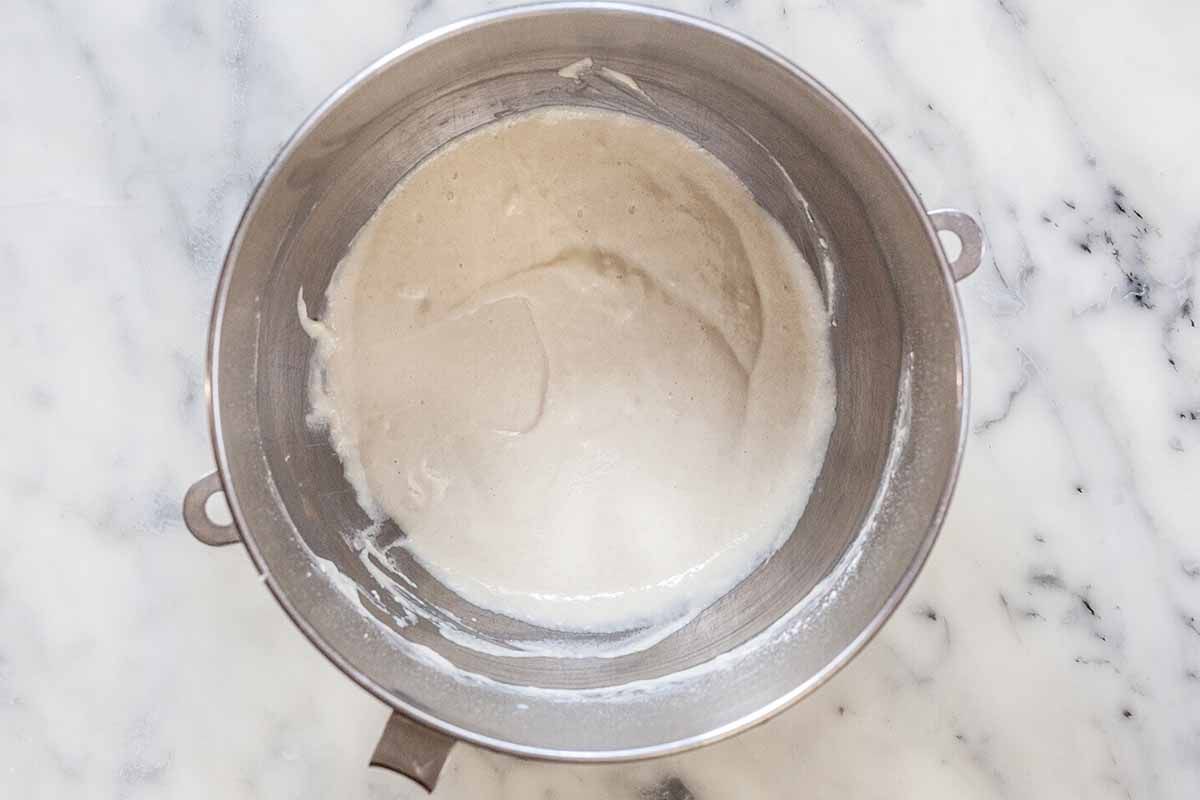 Sponge starter in a silver mixing bowl for Stollen recipe.