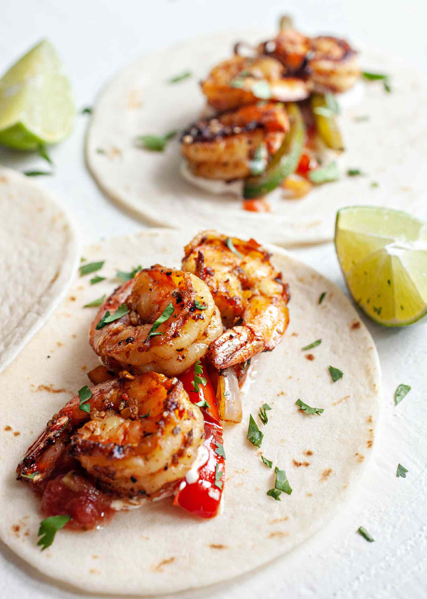 Shrimp Fajitas on two tortillas with lime wedges