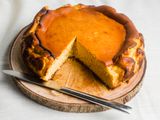 Basque-style cheesecake with slices cut out of it.