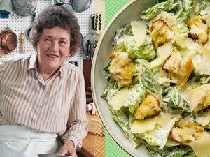 Julia Child next to a Caesar salad in a kitchen setting