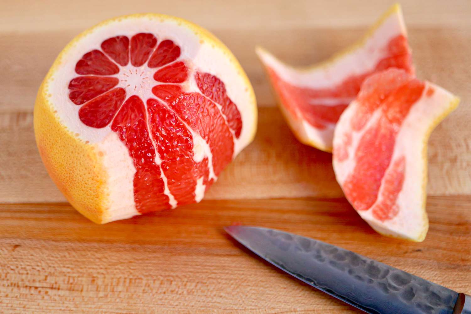 Citrus with Some of the Rind Cut Off and on the Counter, a Knife and Citrus Rinds