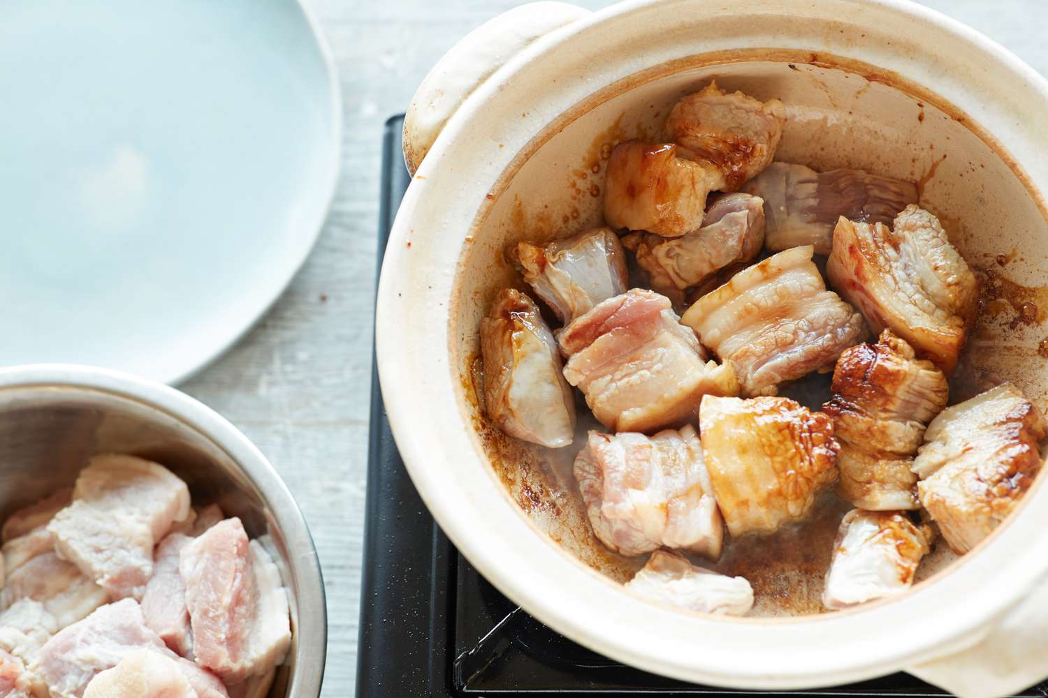 Searing pork belly to make pork belly and eggs braised in sweet coconut water