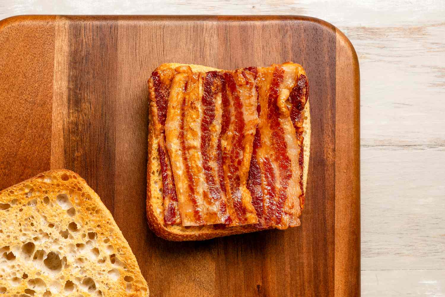 Crispy bacon on a slice of bread
