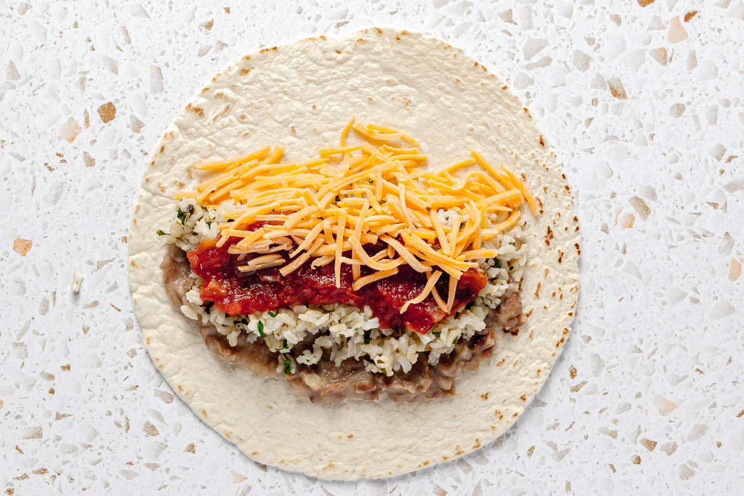 Tortilla on the Counter Topped With Easy Rice and Beans Freezer Burritos Ingredients