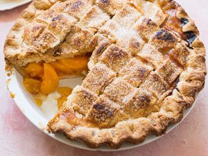 Best Peach Pie with a lattice crust and one slice removed