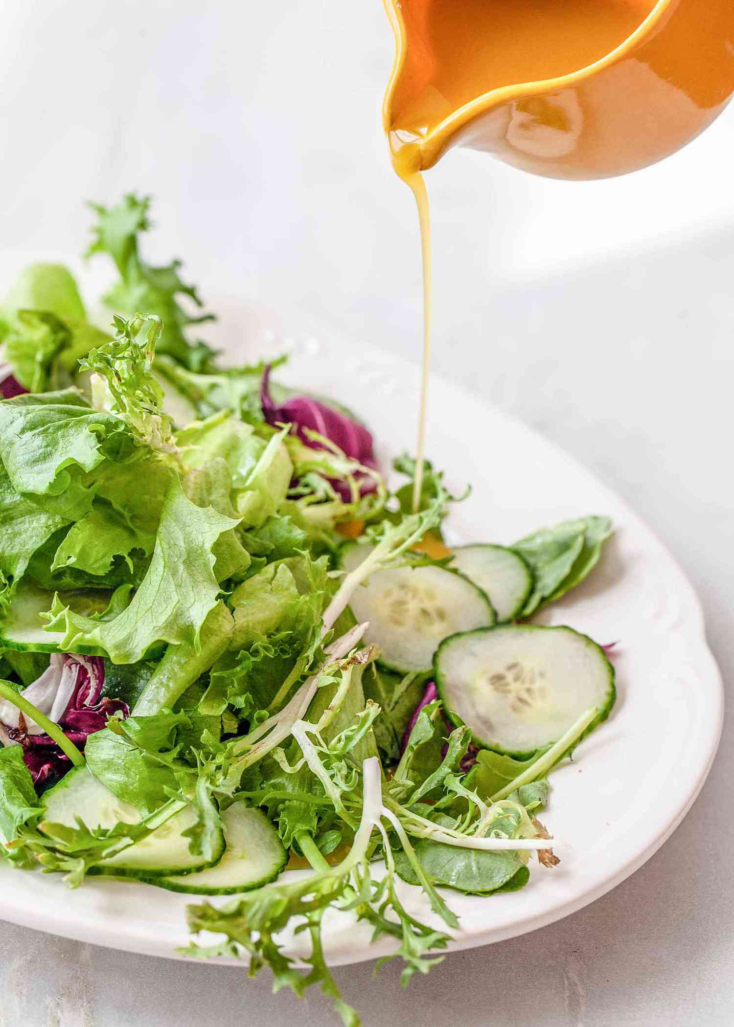 Best Honey Mustard Dressing - - honey mustard dressing over a salad