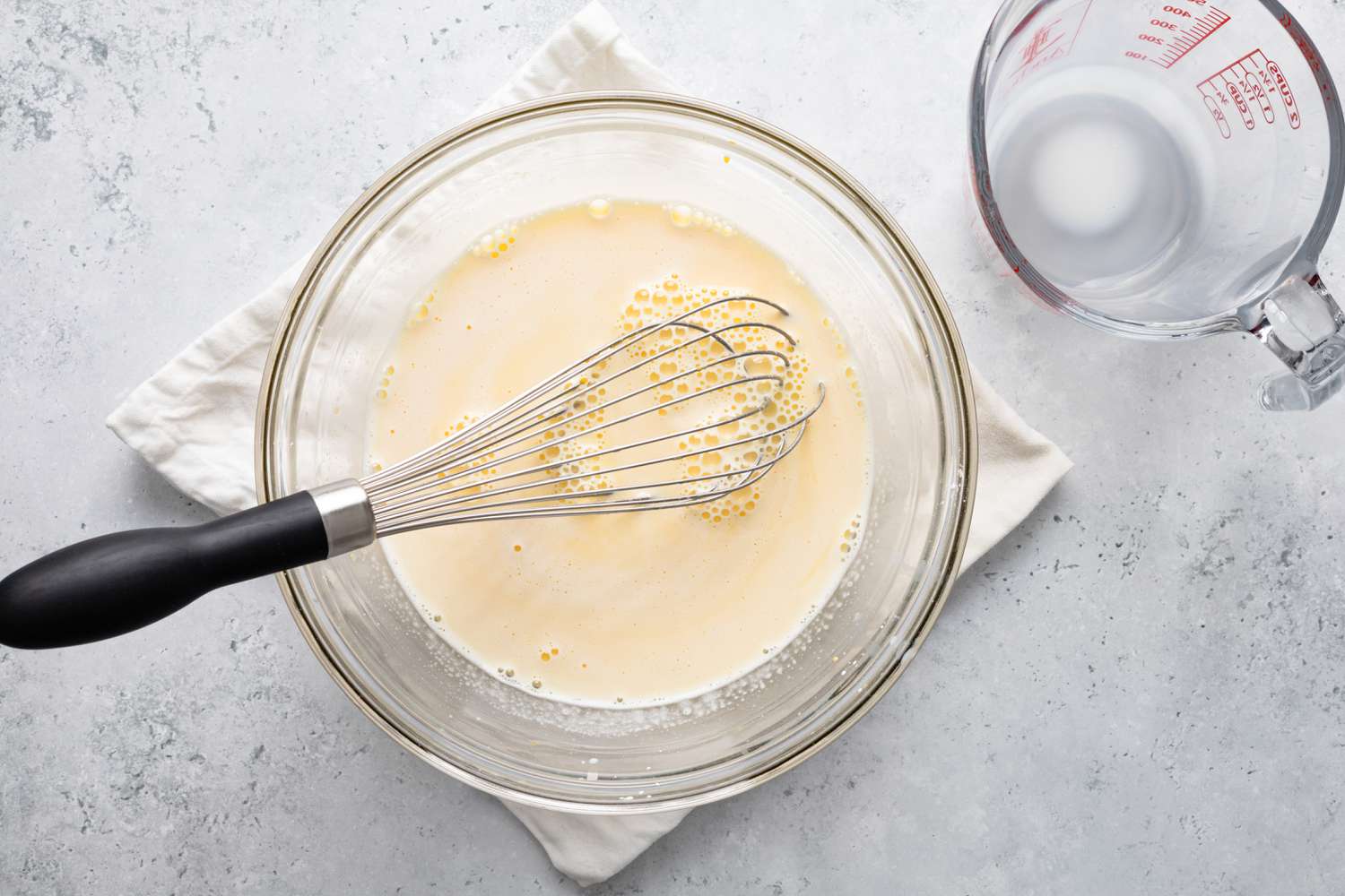 Milk and Egg Yolk Mix in a Bowl for Bee Sting Cake Recipe