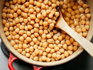 How to Cook Dry Beans - chickpeas in a Dutch oven with a wooden spoon