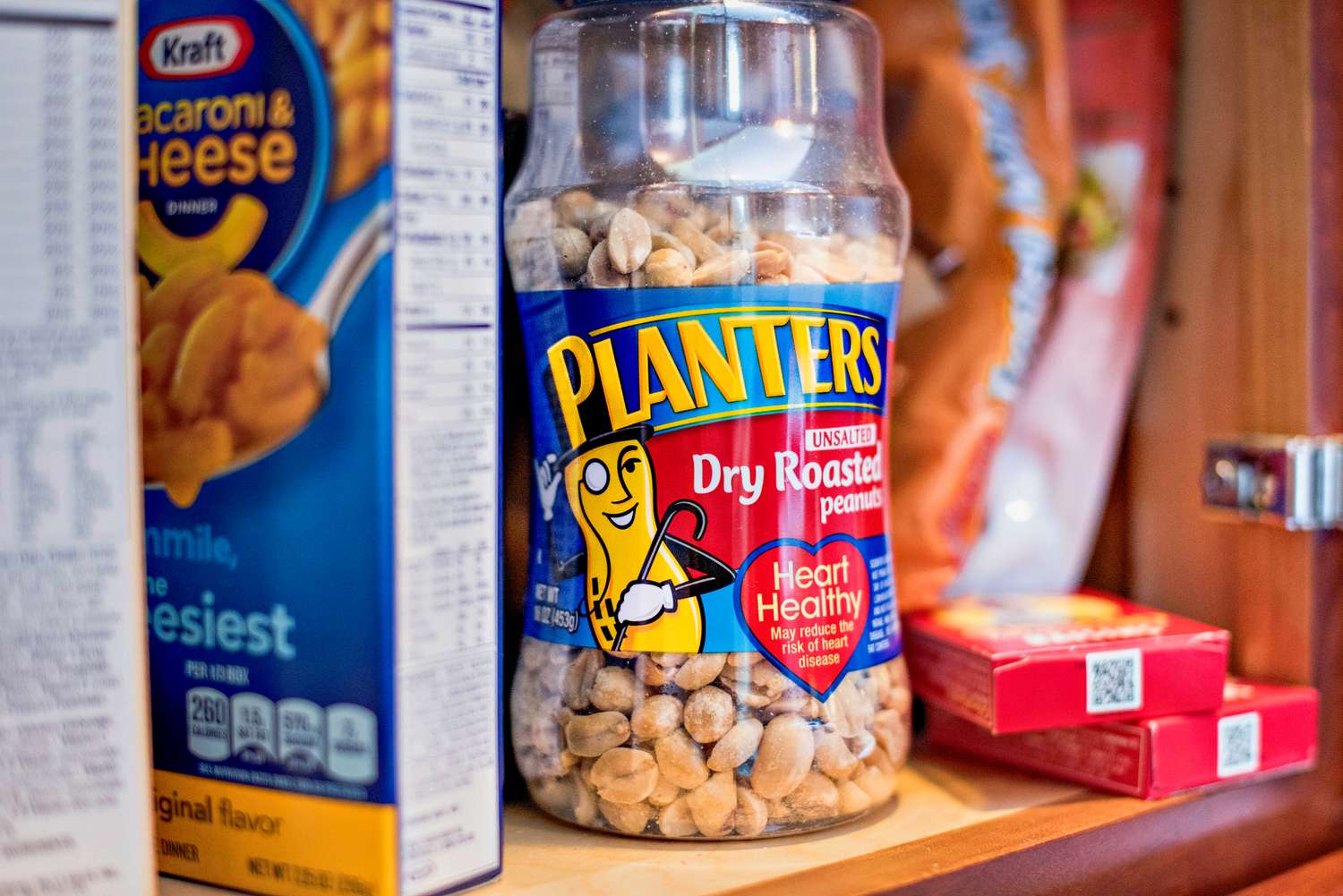 jar of planter's in a kitchen cabinet 
