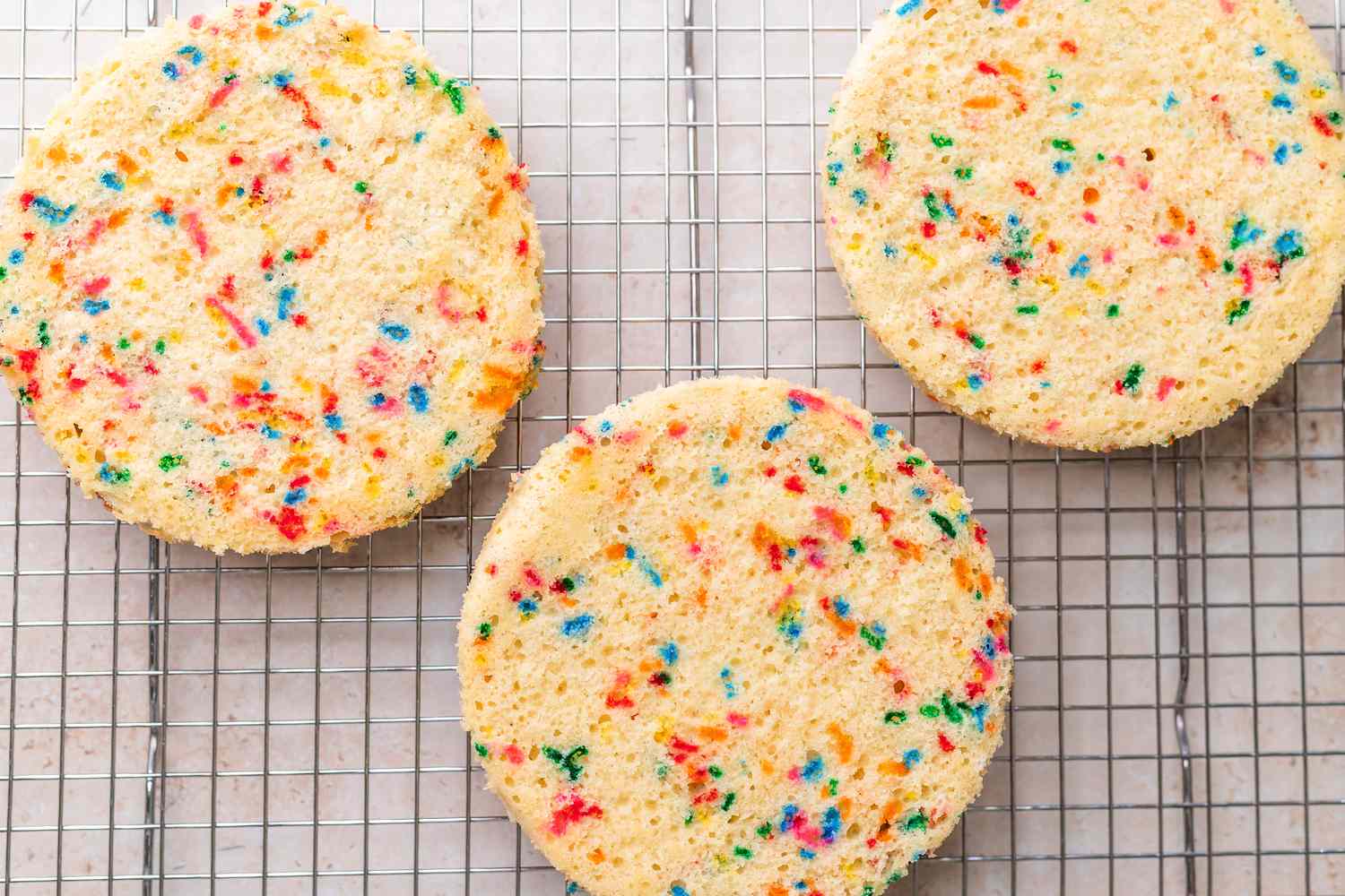 Unicorn Cake Layers Chilling on Cooling Rack