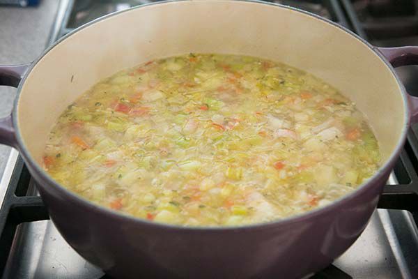 cooking summer minestrone soup on stovetop