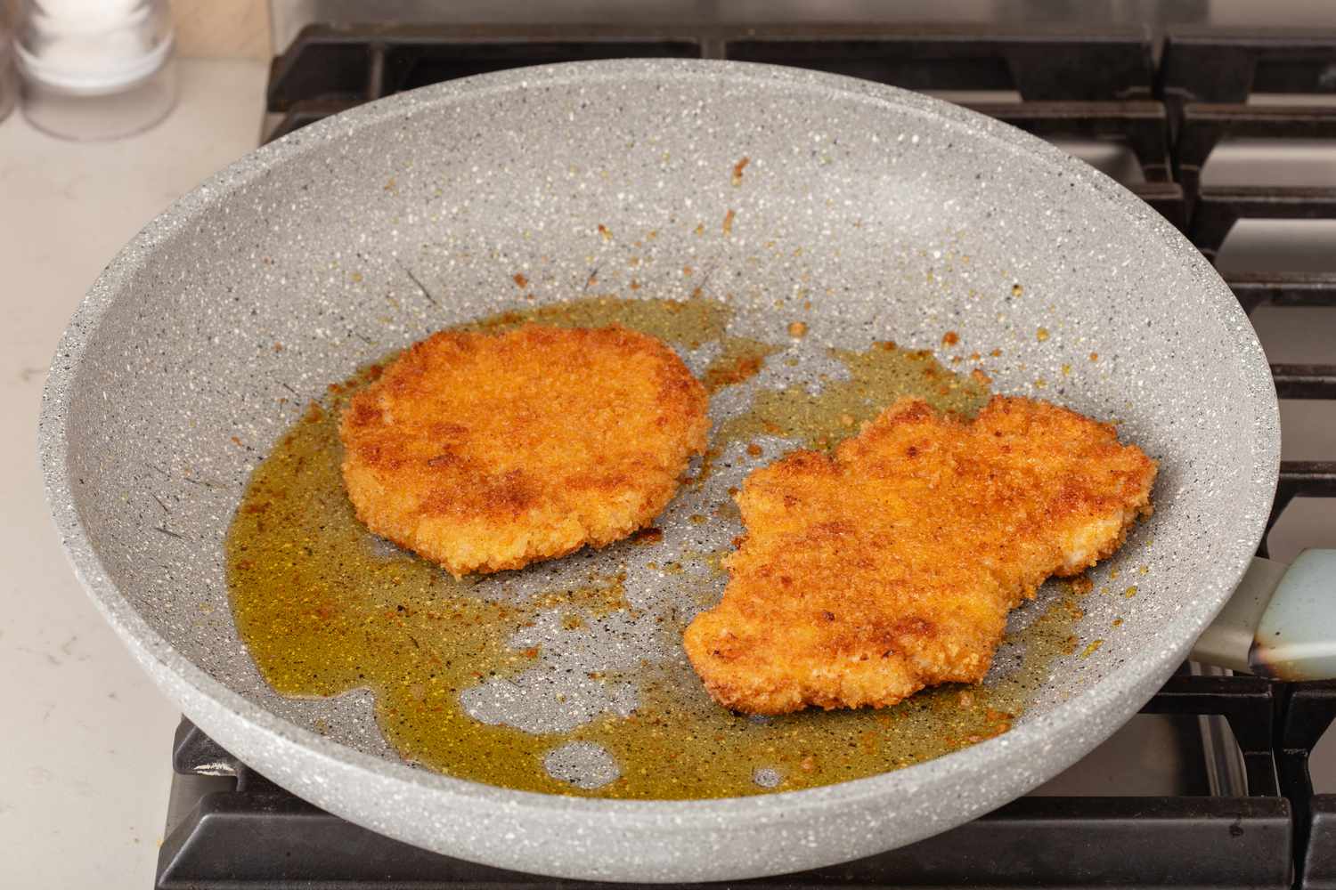 Pan frying pork to show what is schnitzel.