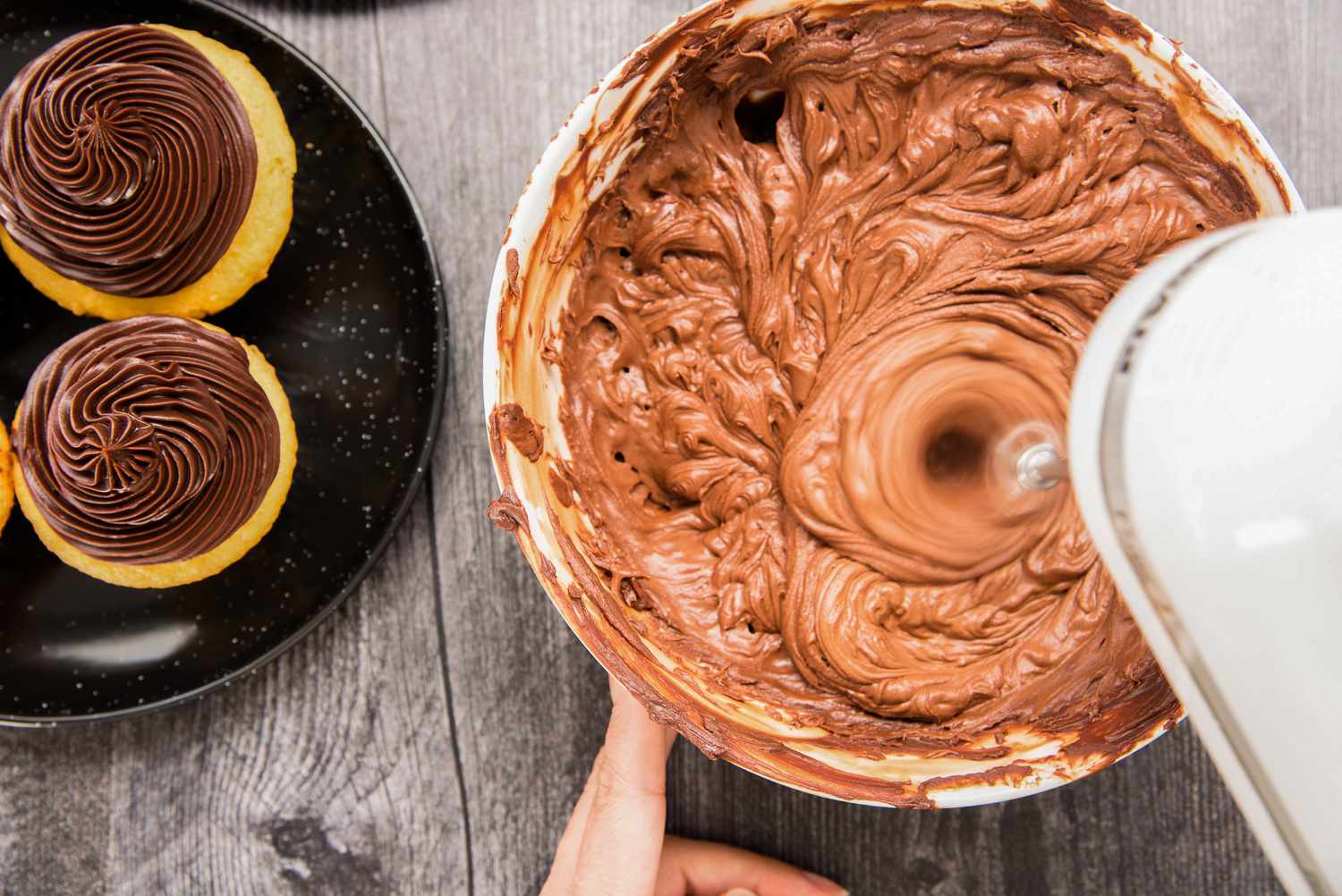 A hand mixer mixing ganache to show how to make chocolate ganache