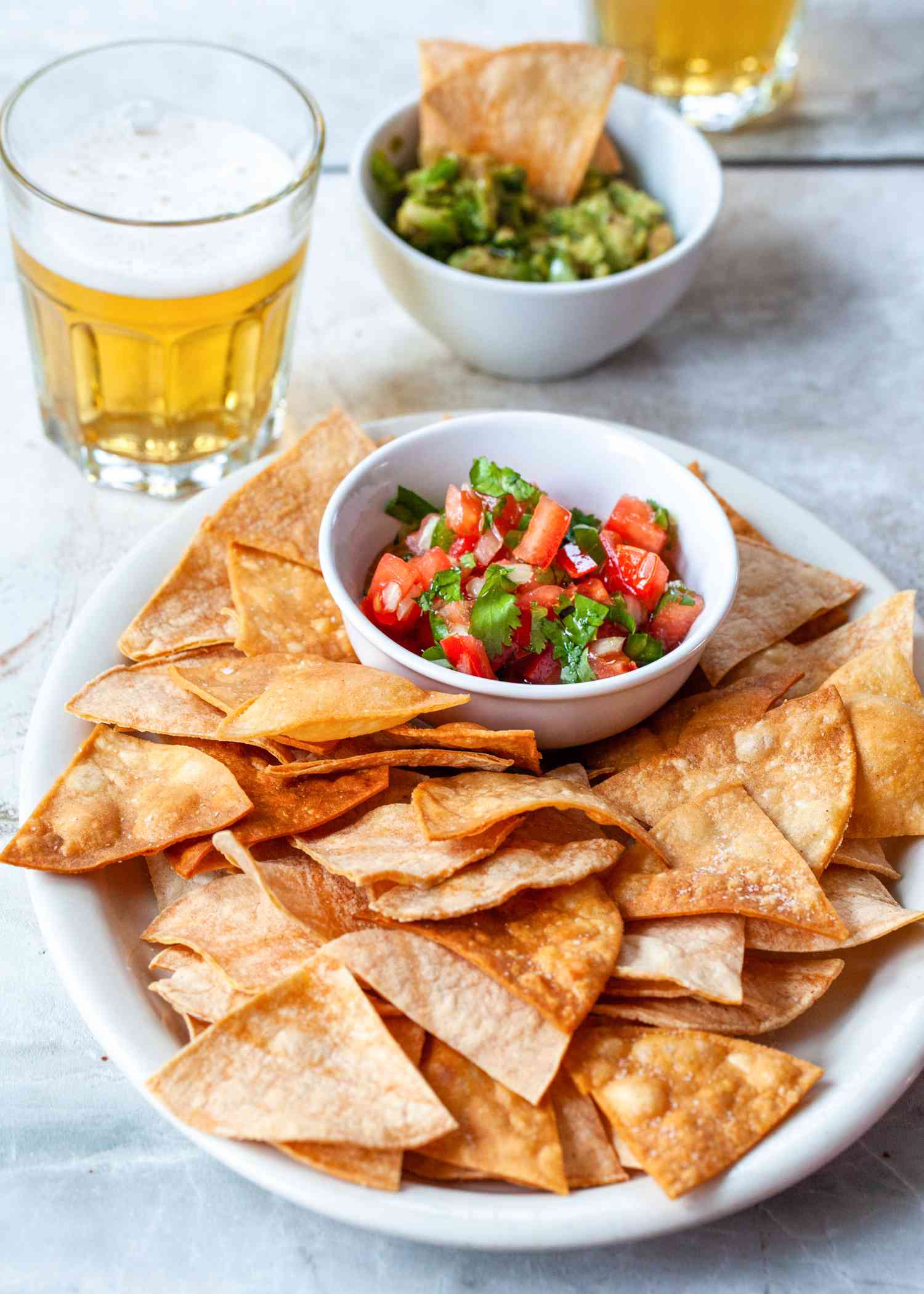 A plate of tortilla chips and salsa.
