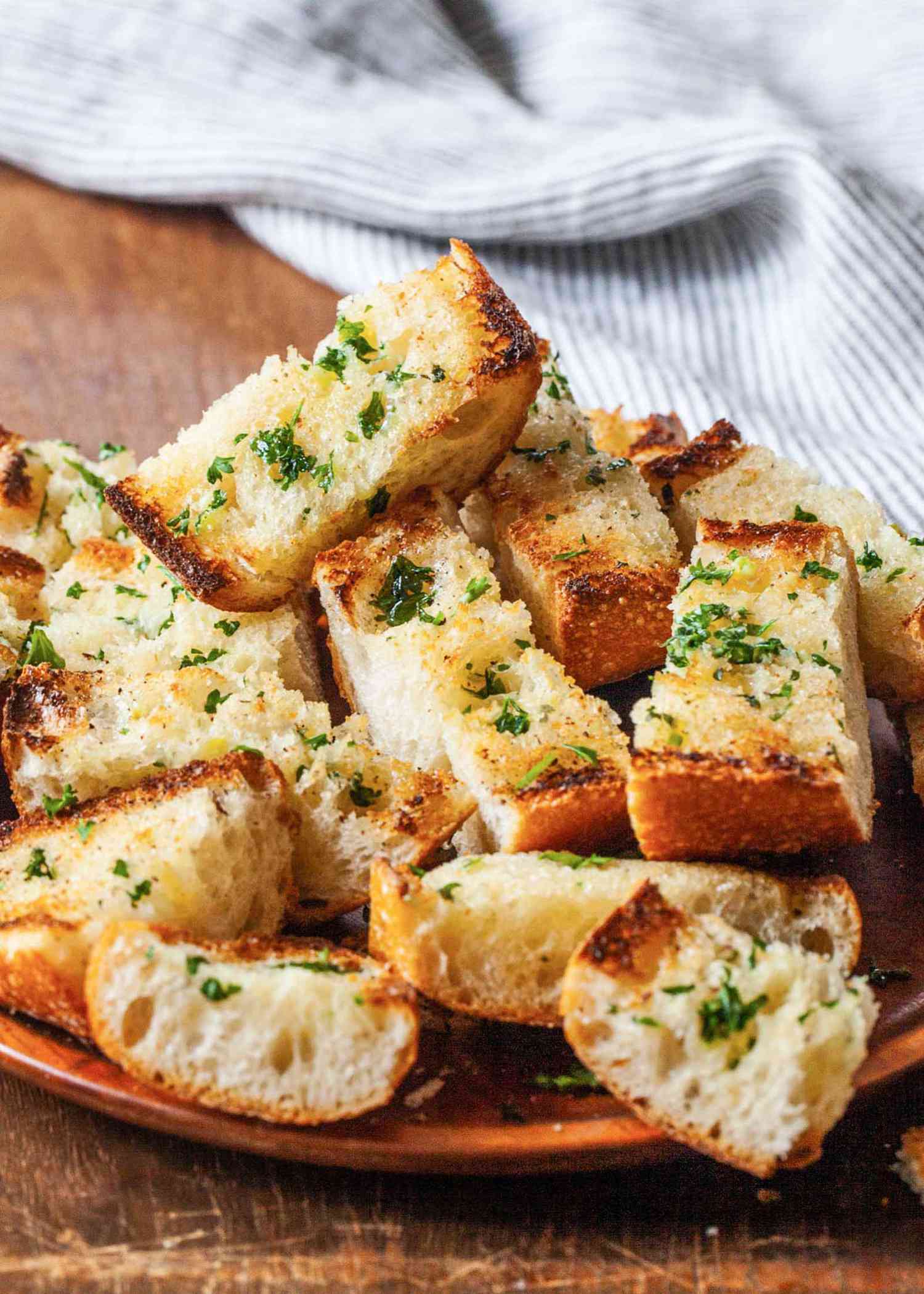 A pile of sliced garlic bread on a platter