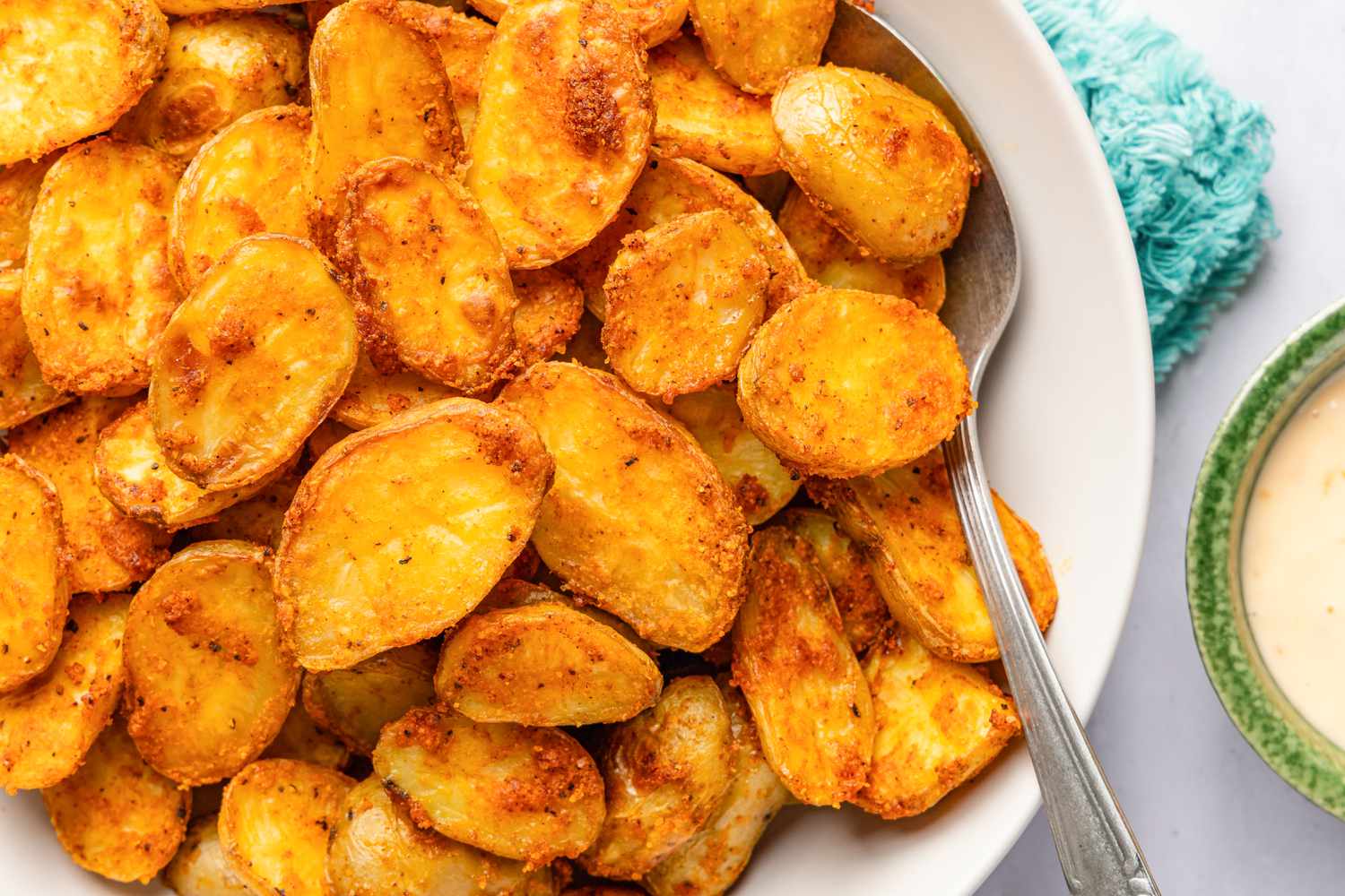 Bang bang potatoes (potatoes in one bowl, sauce in another bowl next to the potatoes)