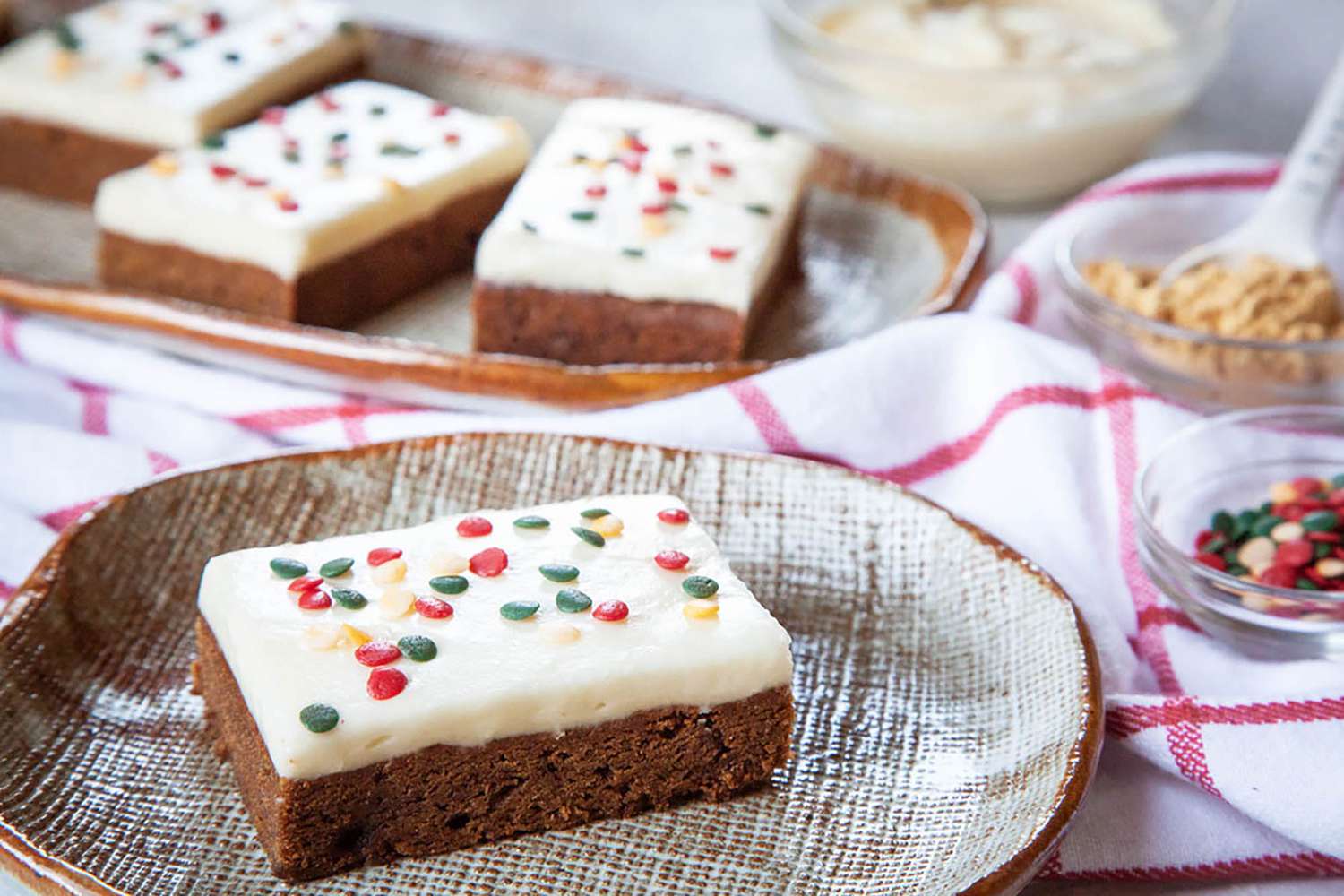 Side view of the Best Gingerbread Bars frosted and topped with festive sprinkles.