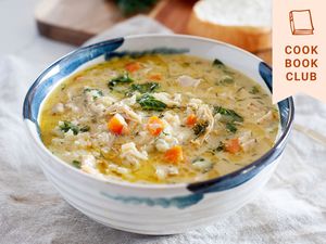Yasmin Khan’s Lemon Chicken Soup in a bowl with a white linen underneath it.
