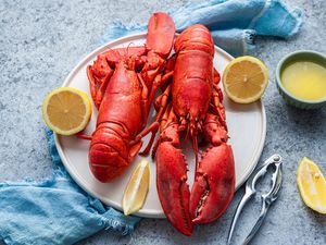 Plate of Lobster with Lemon Halves and a Bowl of Butter Sauce
