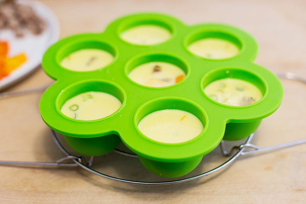 Uncooked egg bites in a silicon mold ready to be cooked.