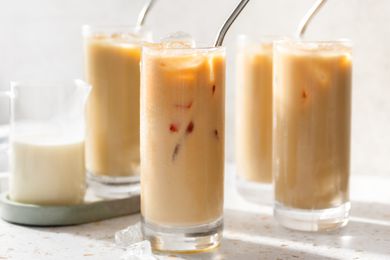 Glasses of Thai Iced Tea and a Creamer Filled With Milk