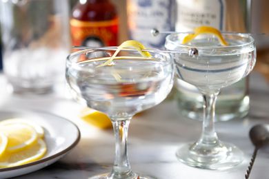 Close up of two Gin Martini Cocktails garnished with lemon twists.