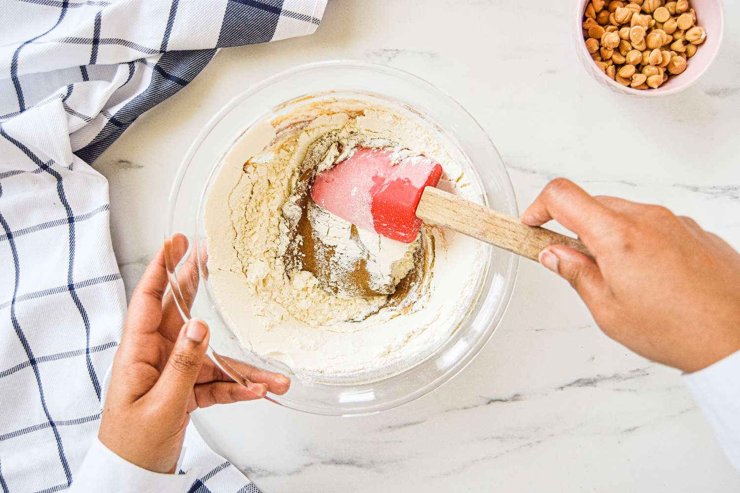 Mixing dry ingredients to make a blonde brownie recipe.