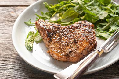 Easy Pork Chop Recipe pork chop and greens on plate