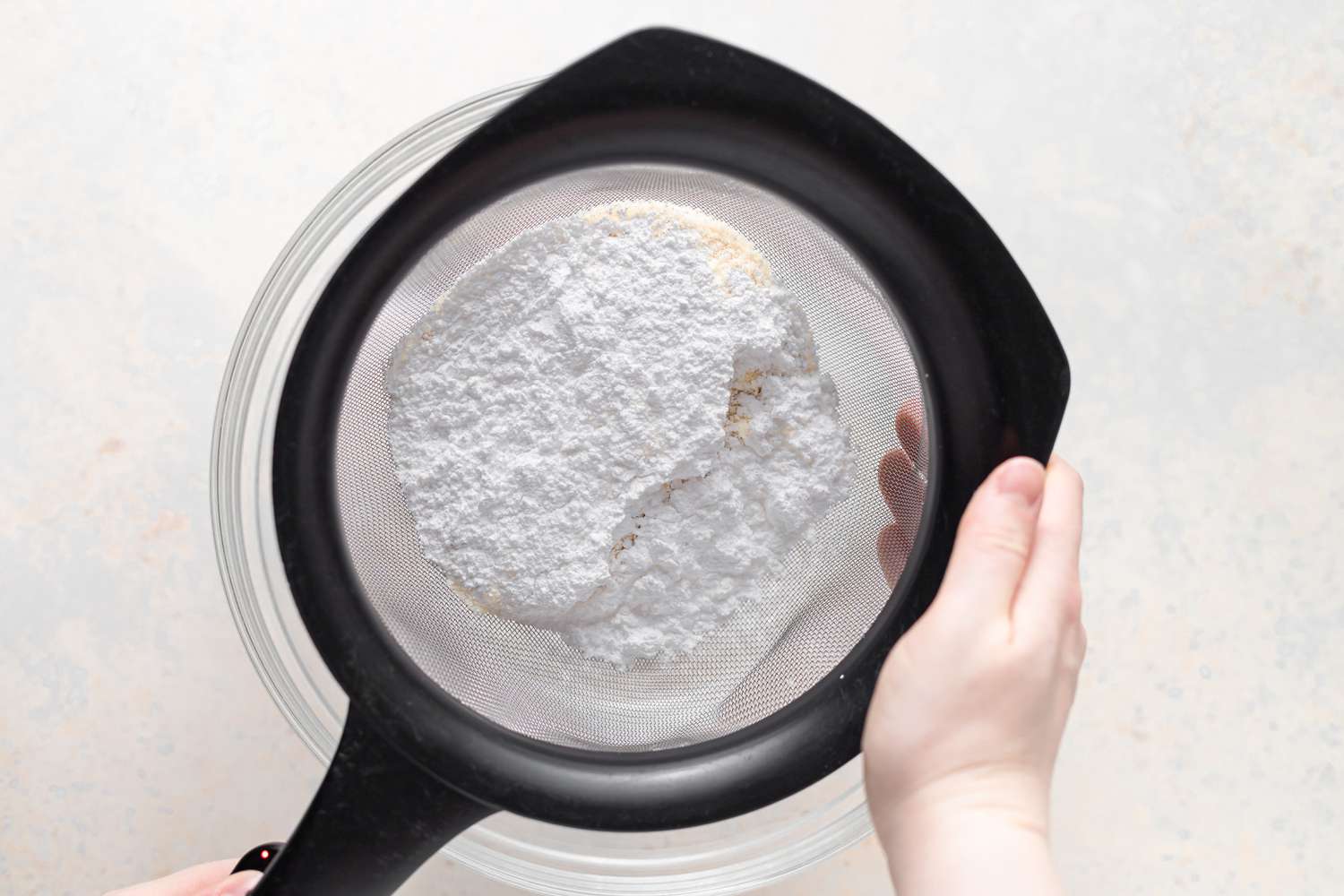 Sifting flour to make French macarons with peppermint white chocolate filling