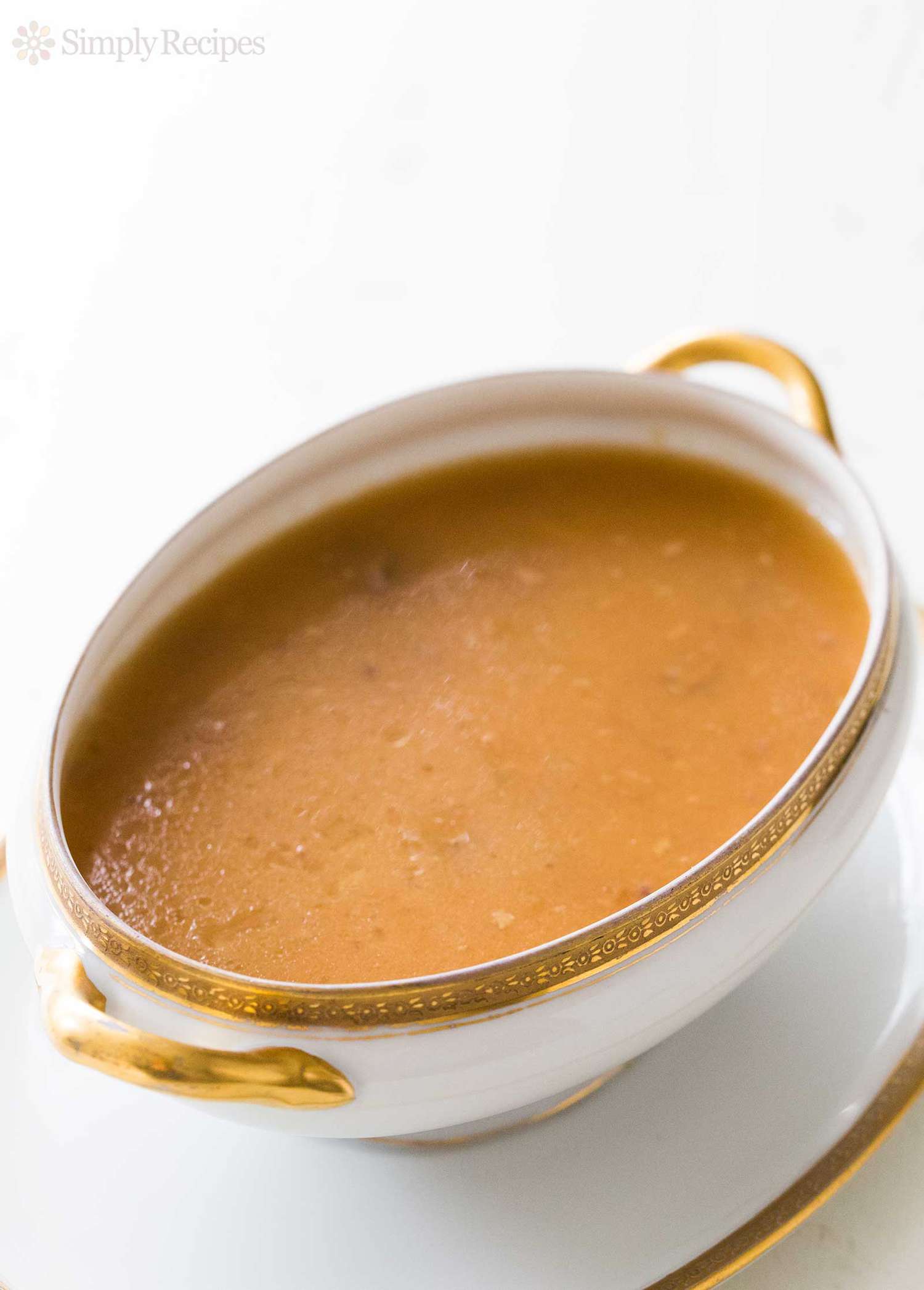 A white gravy boat full of gravy 