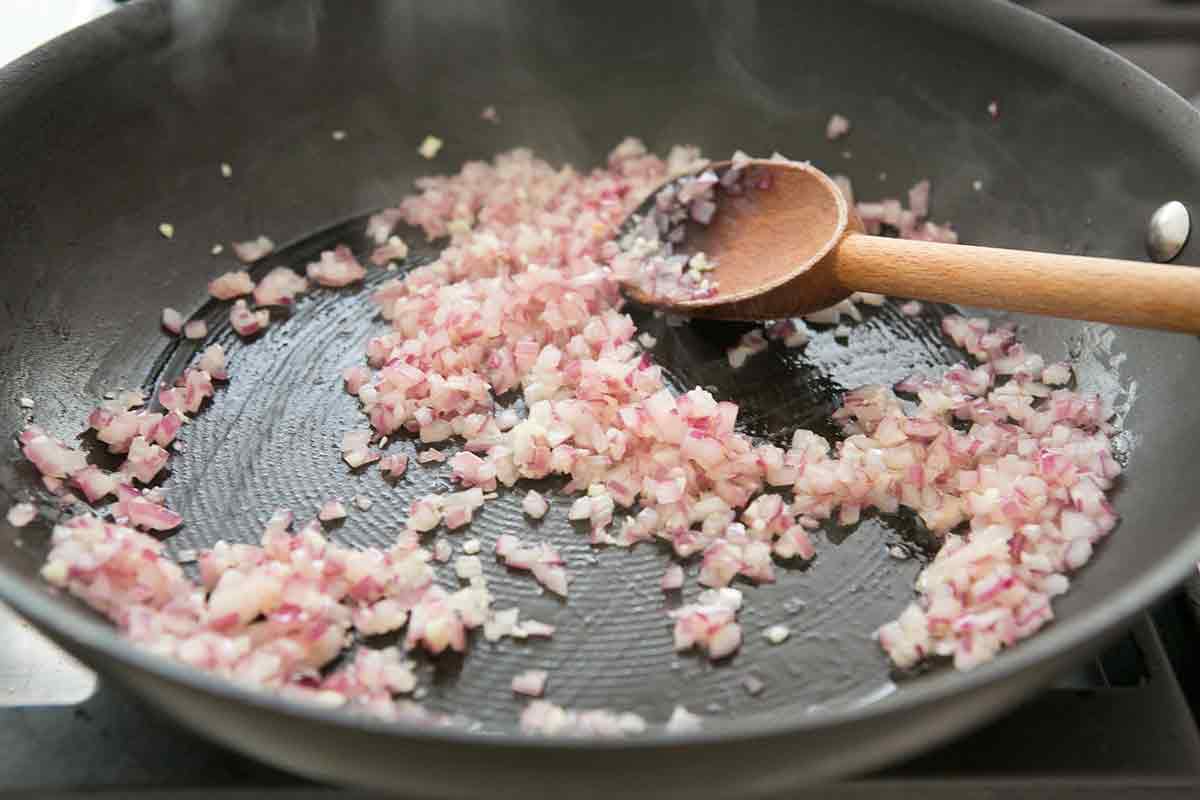 sautéing onions and garlic in a pan