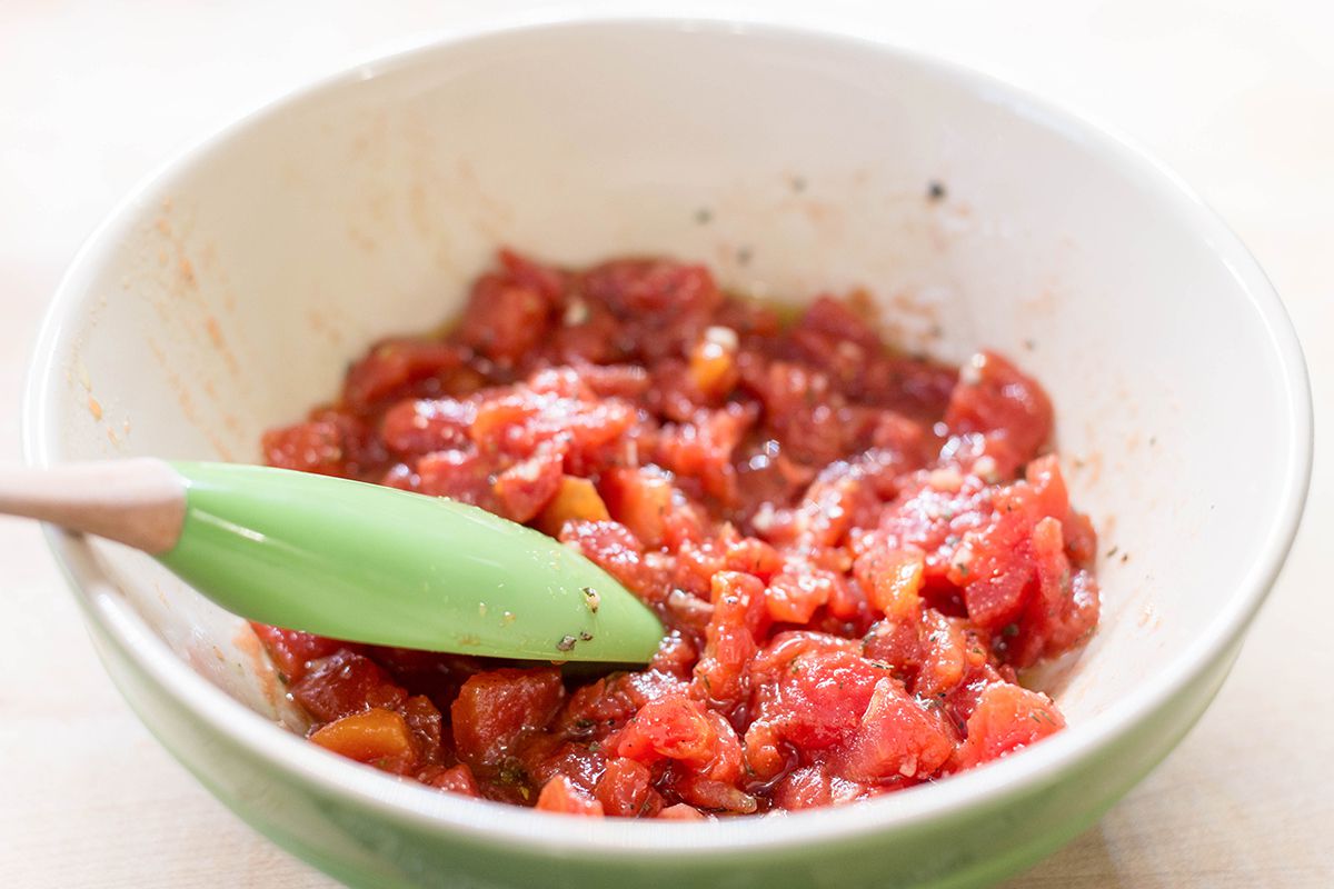 Mix together the tomato topping for Cheesy Bruschetta Chicken Cutlets