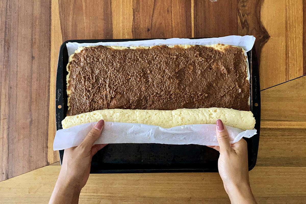 Parchment paper used to help roll the best gluten free cinnamon rolls into a spiral.