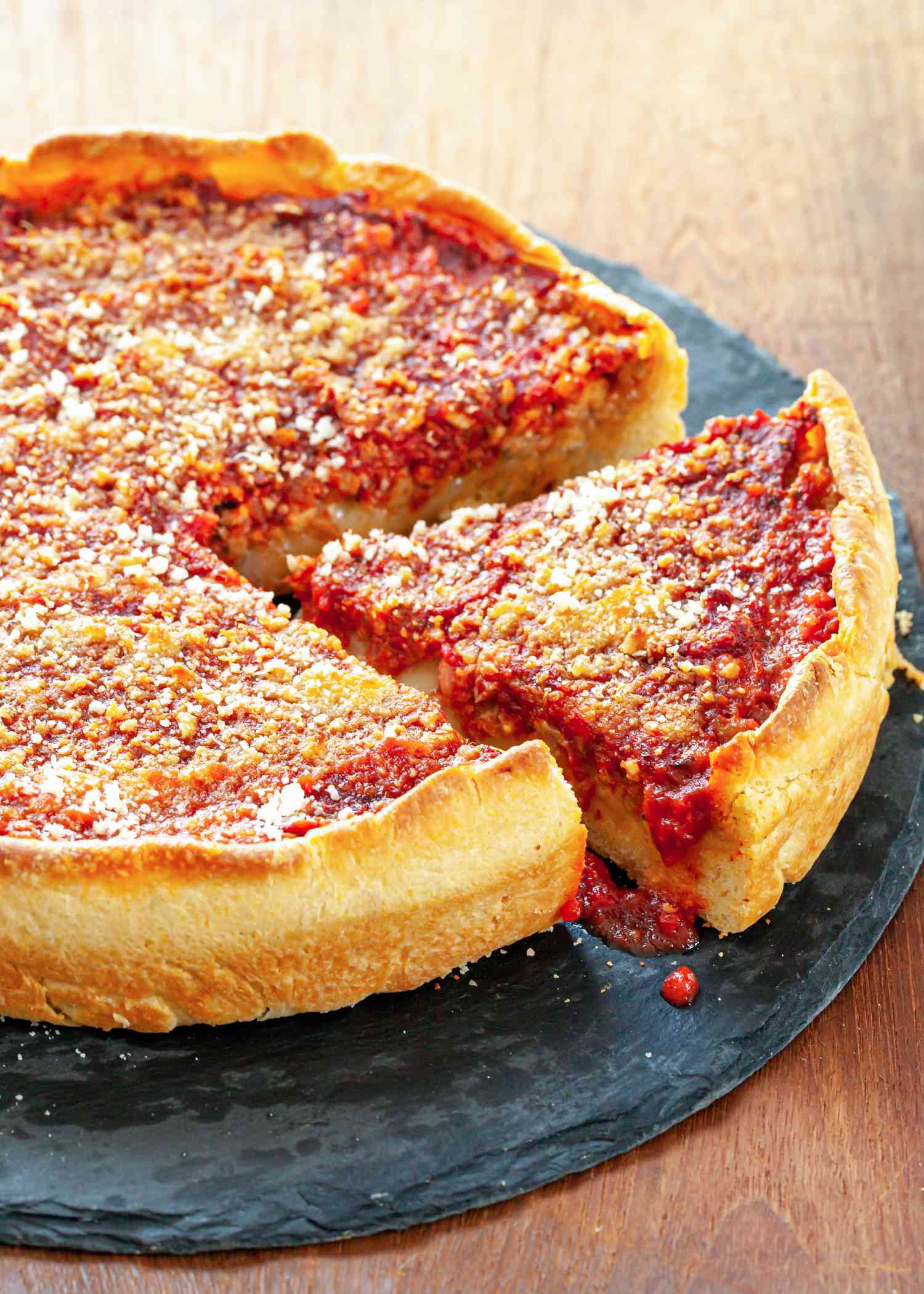 Homemade Chicago-Style Deep Dish Pizza with one slice cut.