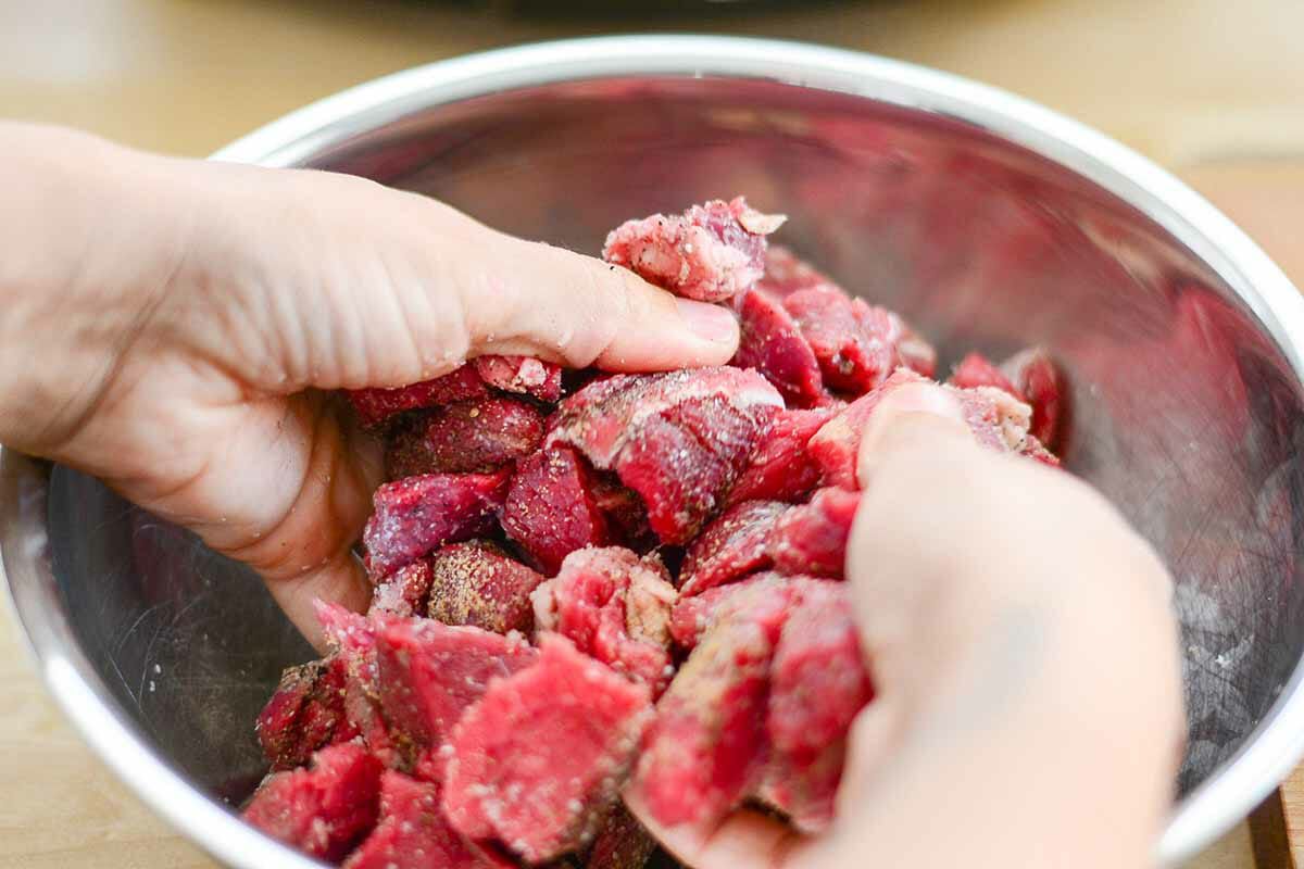 Tossing the meat for Slow Cooker Beef Stroganoff