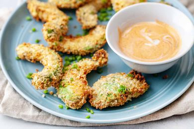 Air fryer avocado slices on a blue plate with dipping sauce