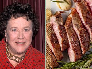 Julia Child next to a display of cooked steak slices
