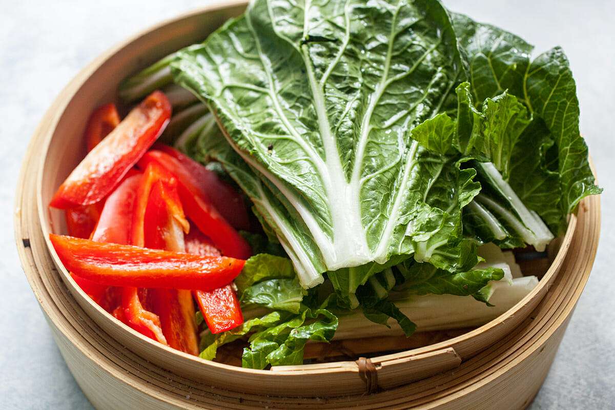 Steamed Salmon with Ginger assemble the veggies in the steamer