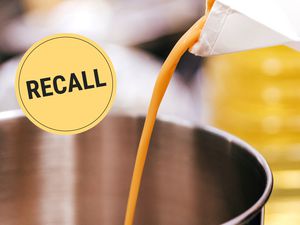 Liquid eggs being poured from a carton into a saucepan with a "Recall" badge superimposed on the image