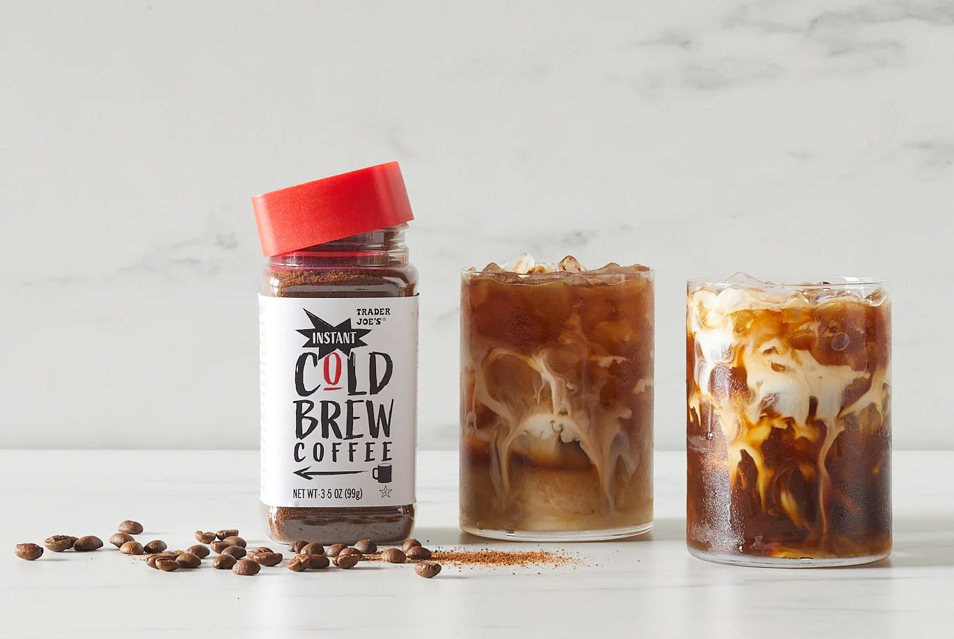 Trader Joe's Cold Brew Coffee jar next to two glasses of ice coffee