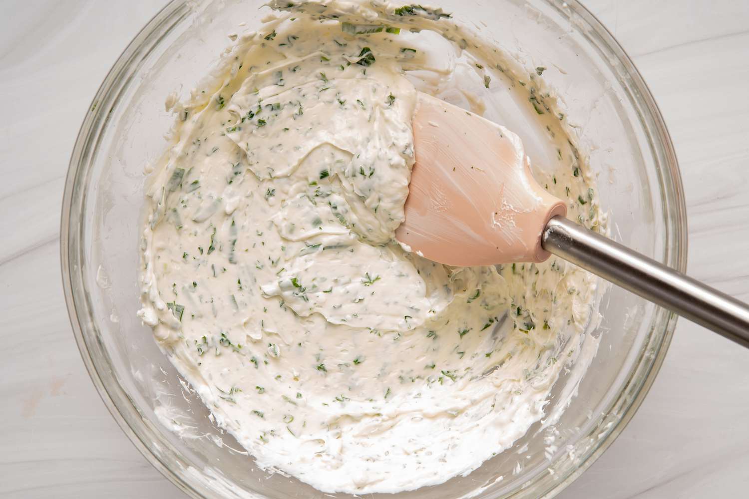 How to make crab dip by mixing ingredients in a glass bowl.