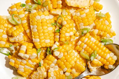 Cooked corn cut into pieces with sliced green onions
