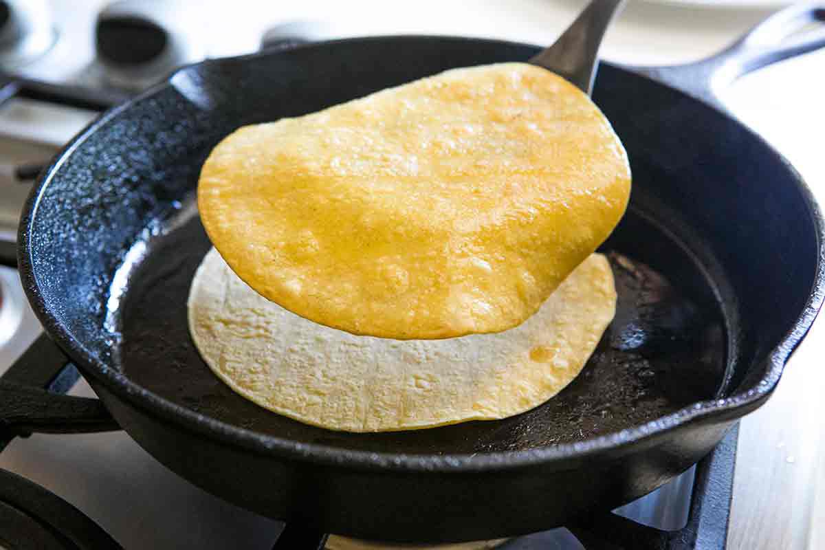 stack fried tortilla on top of newly placed tortilla to soften tortillas for enchiladas