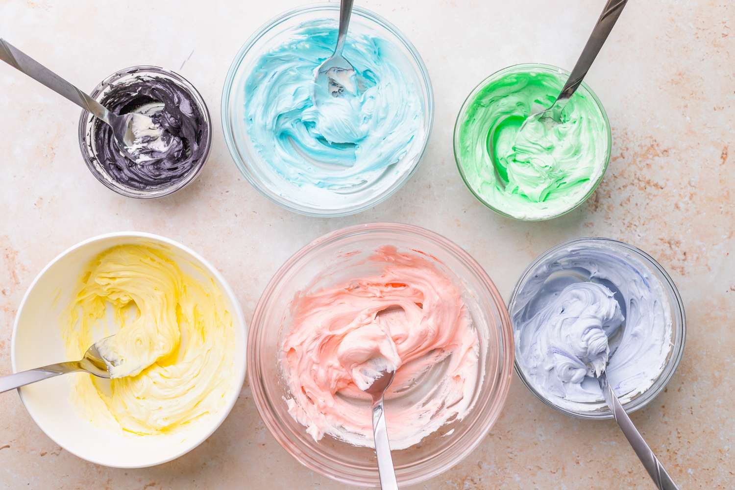 Bowls of Buttercream Colored in Pastel Rainbow Colors for Unicorn Cake 