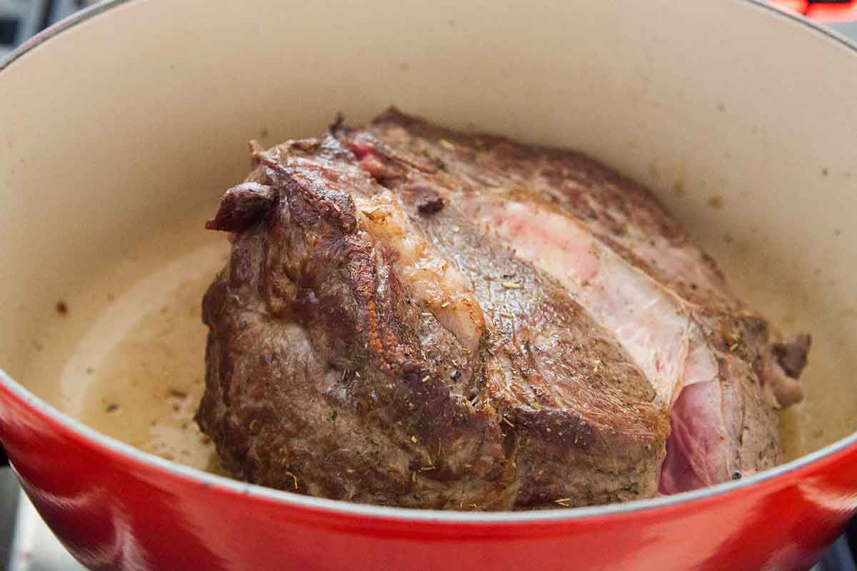 Browning Beef Shoulder cooking in a Dutch oven