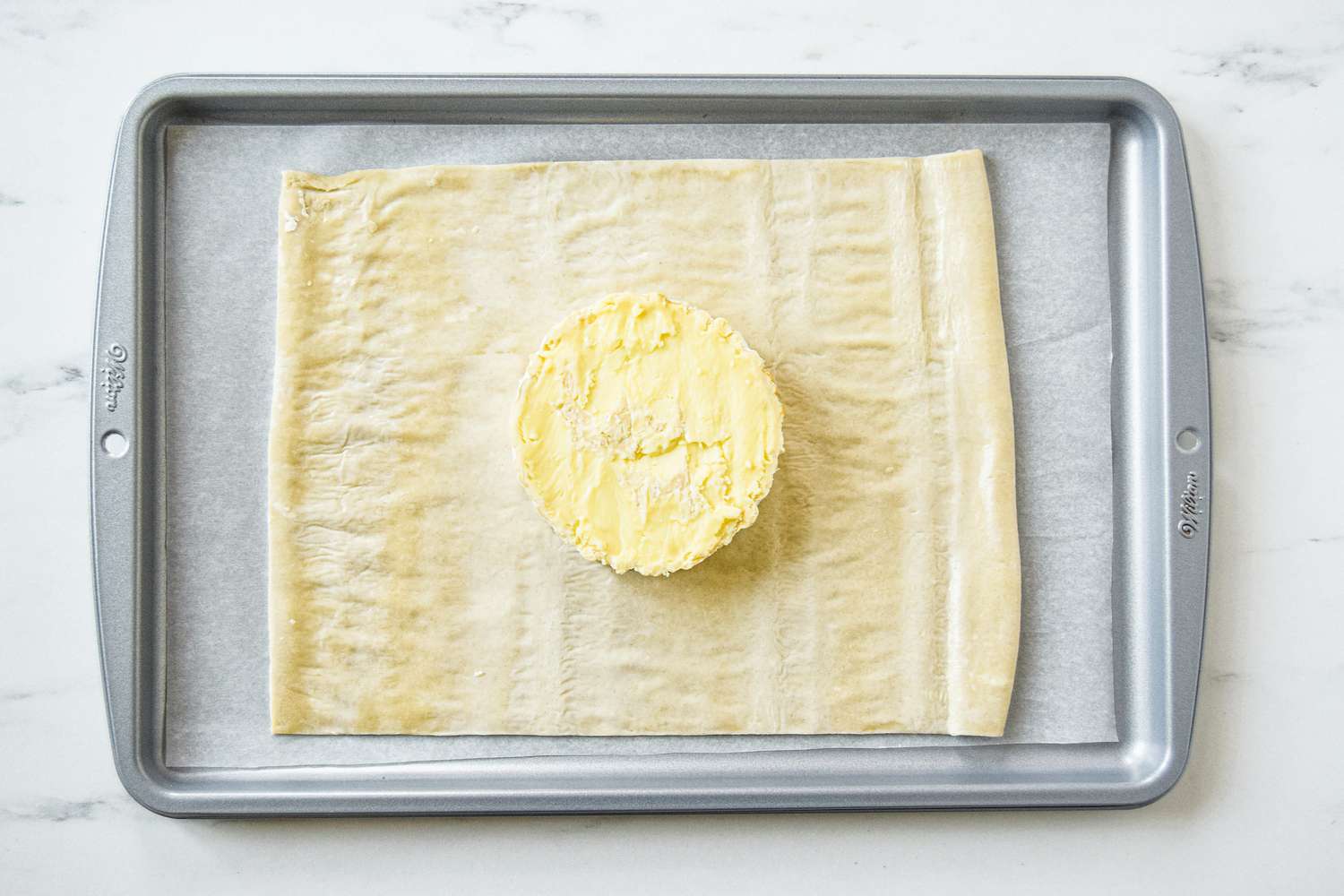 Puff pastry with brie set on top to make baked brie