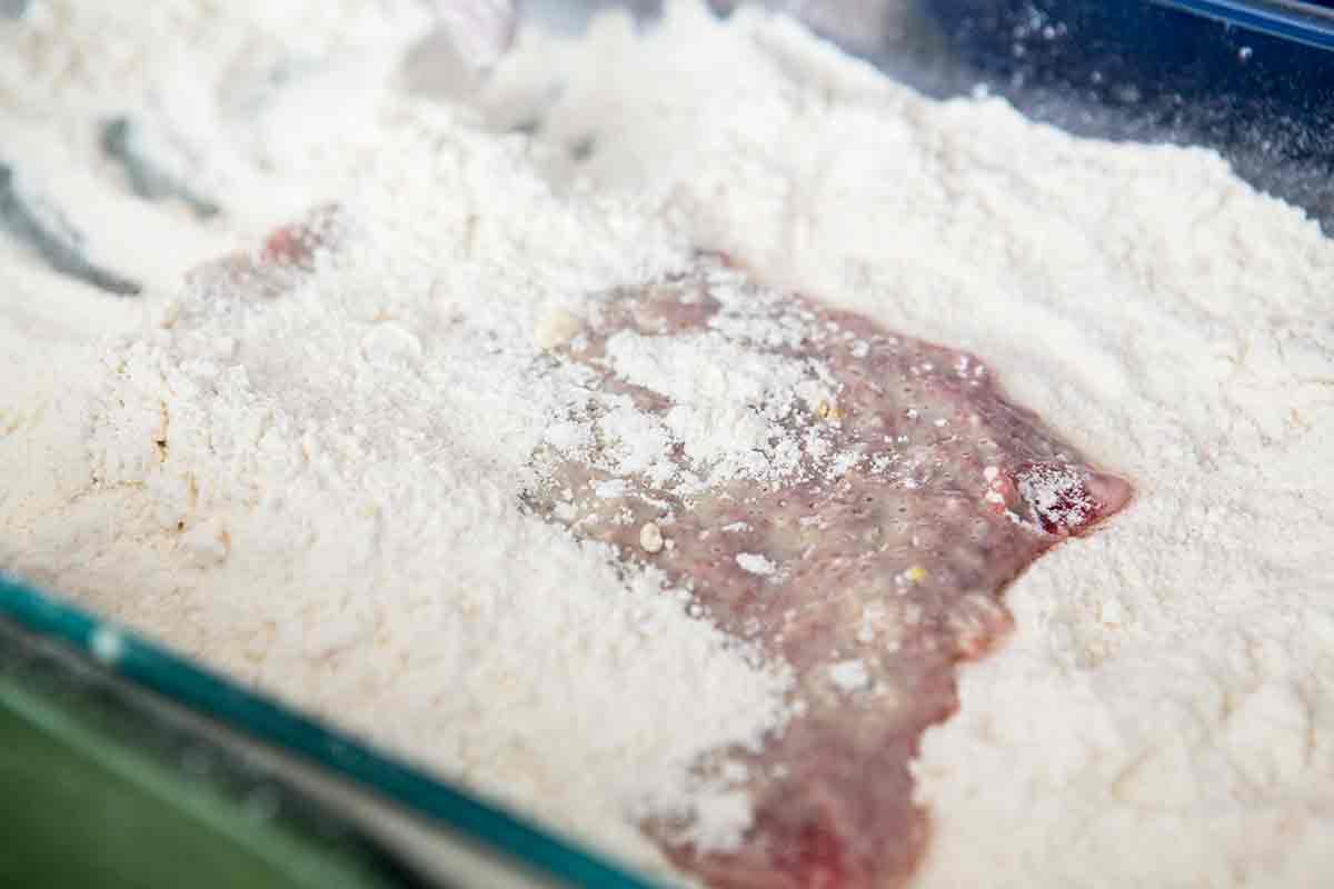 Chicken friend steak in flour and egg before frying