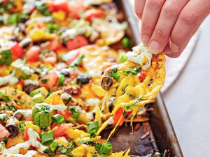 Pulling a loaded chip away from a sheet pan of nachos