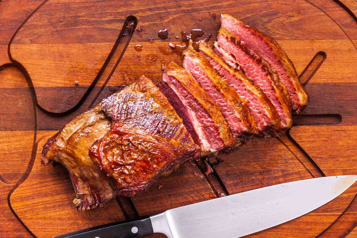 How to Cook Corned Beef and Cabbage - sliced corned beef on a cutting board